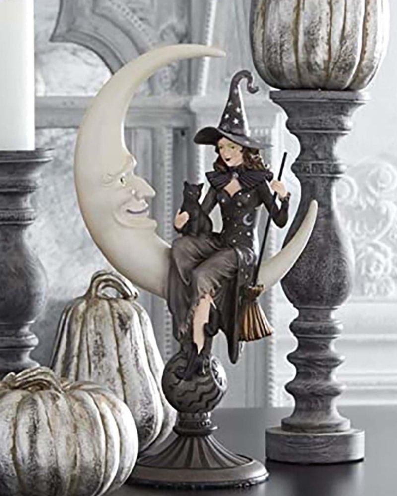 Crescent moon witch Halloween decoration with pumpkins and candle holders