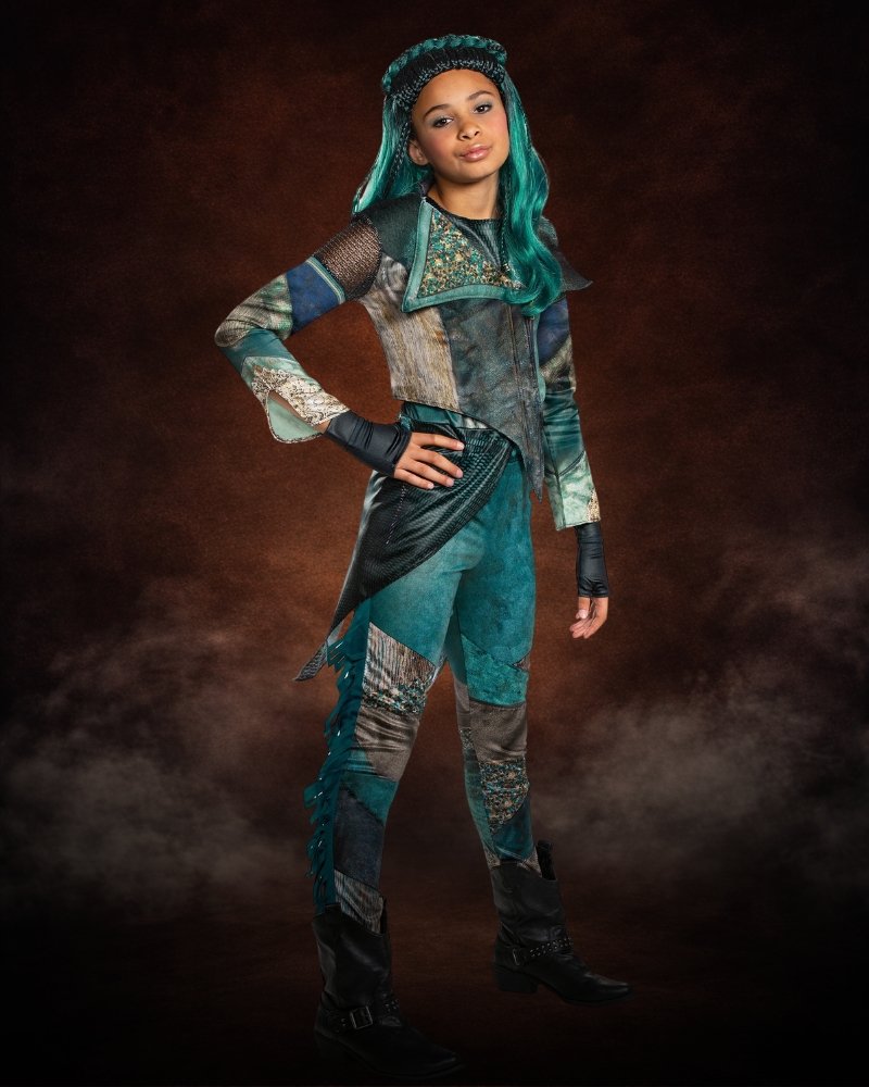 Girl wearing deluxe Disney Descendants 3 Uma costume with teal pirate jacket, textured jumpsuit, gloves, and green wig