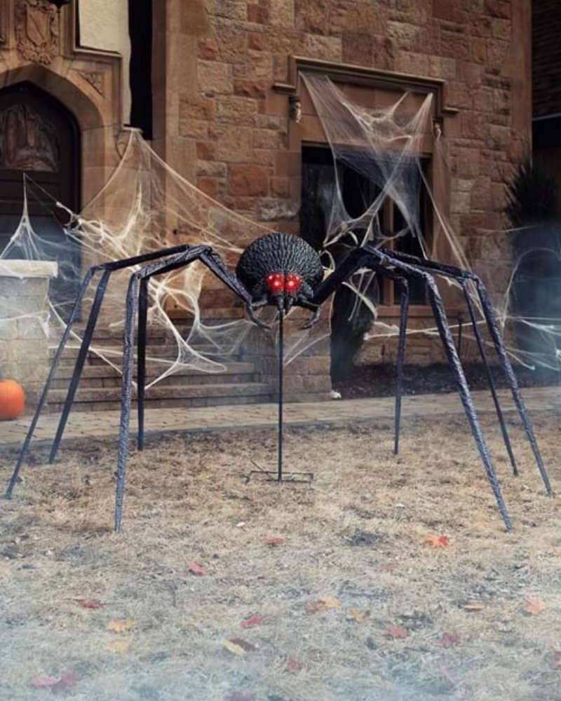 Giant animated Halloween spider yard decoration with glowing red eyes