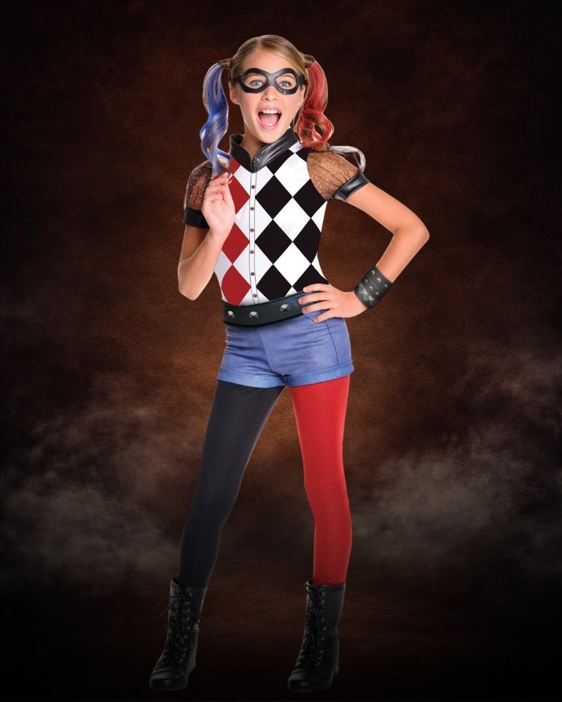 Girls deluxe Harley Quinn costume with diamond-pattern top, pigtails, mask, and DC Super Hero-inspired styling