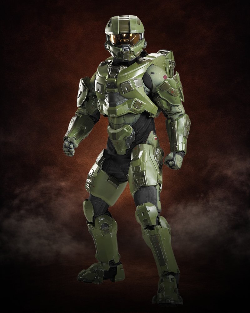 Boy wearing deluxe Halo Master Chief Halloween costume with green armored jumpsuit, foam battle armor, and light-up helmet visor