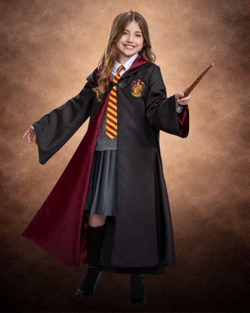 Girl wearing prestige Hermione Granger Harry Potter costume with Gryffindor robe, pleated skirt, striped tie, and Hogwarts crest