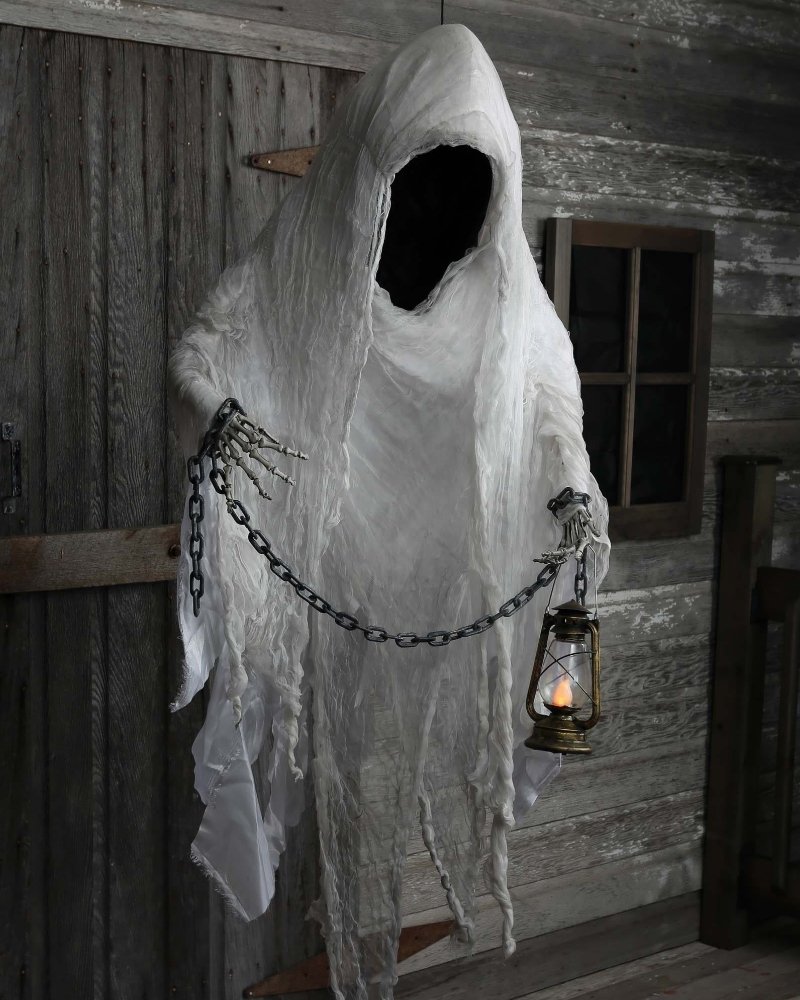 Large hanging faceless ghost Halloween decoration with lantern and chains