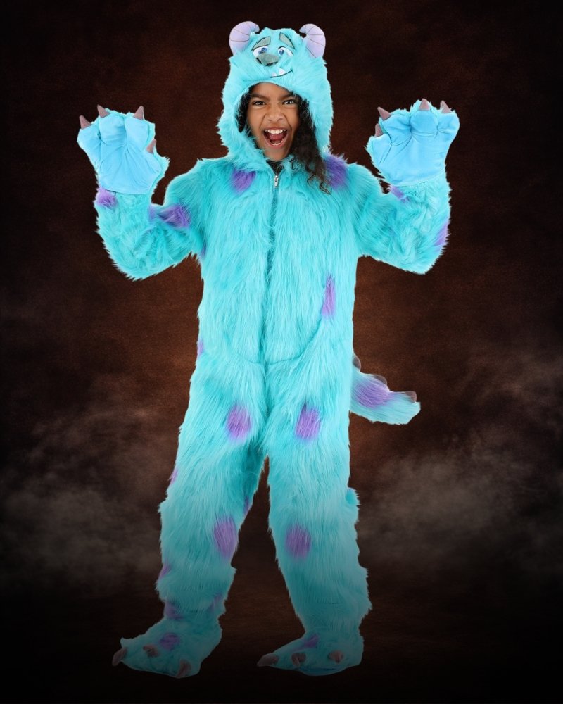 Girl wearing premium Disney Sulley Monsters Inc Halloween costume with blue faux fur hood, claws, tail, and purple monster spots