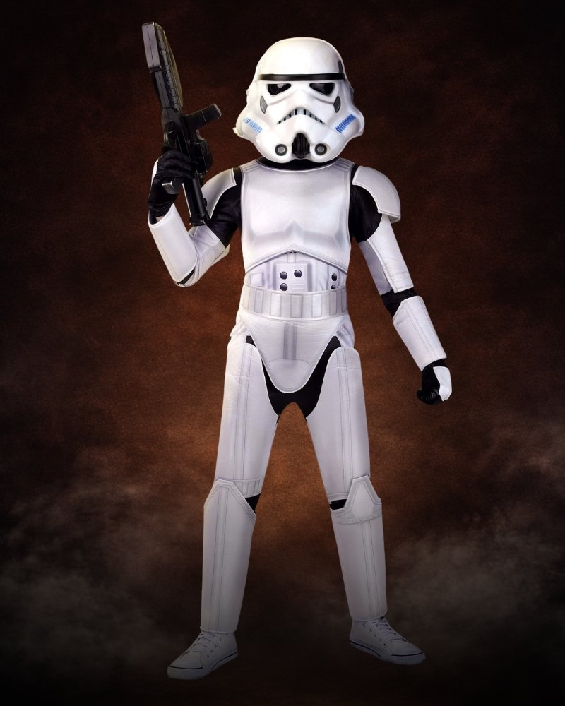 Kid wearing a premium Star Wars Stormtrooper Halloween costume with white armor and character helmet