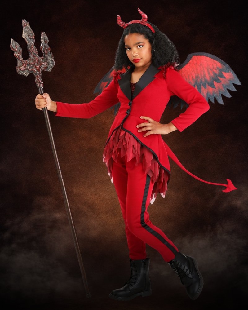 Girl wearing a premium red devil Halloween costume with wings, horns, and sparkling details