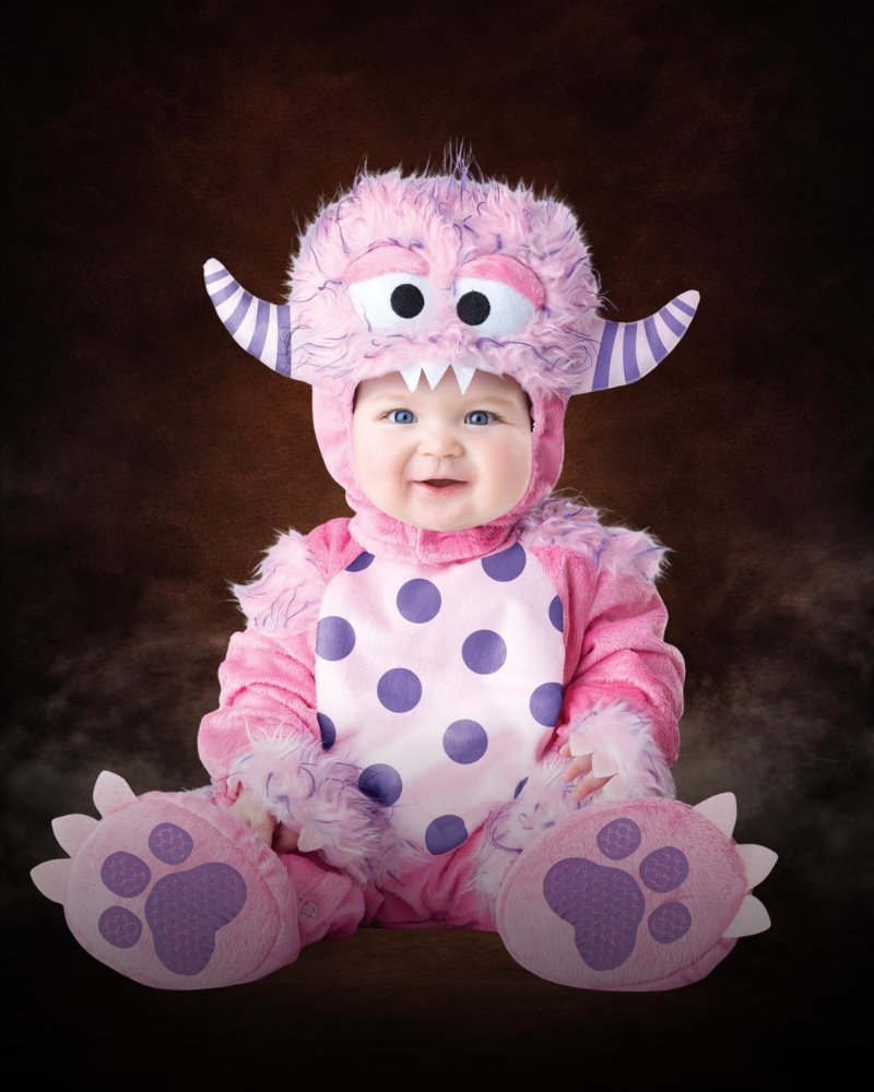 Infant toddler pink monster costume with faux fur, purple polka dots, striped horns, and oversized monster headpiece