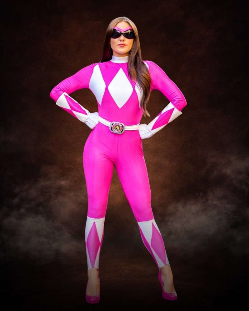 Officially Licensed Pink Ranger Sassy Bodysuit Costume, pink jumpsuit with white diamond details, faux leather belt, gloves and wraparound sunglasses