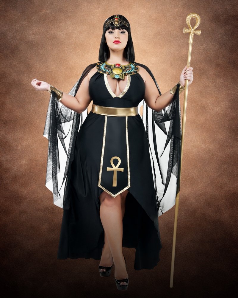 Plus Size Empress Divine Costume for Women with black halter dress, gold trim, jeweled Egyptian collar, gauze cape sleeves and ankh panel