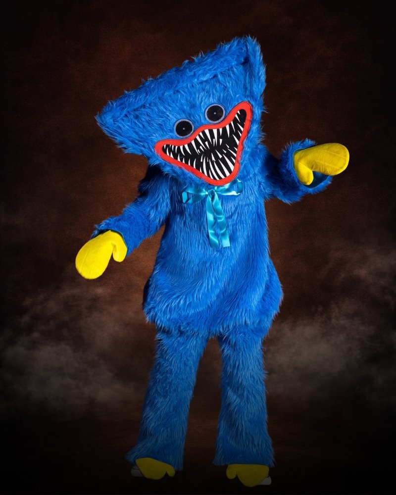 Poppy Playtime Huggy Wuggy Prestige Costume for Kids with bright blue fur, full character mask, satin bow, mitts, and oversized feet.