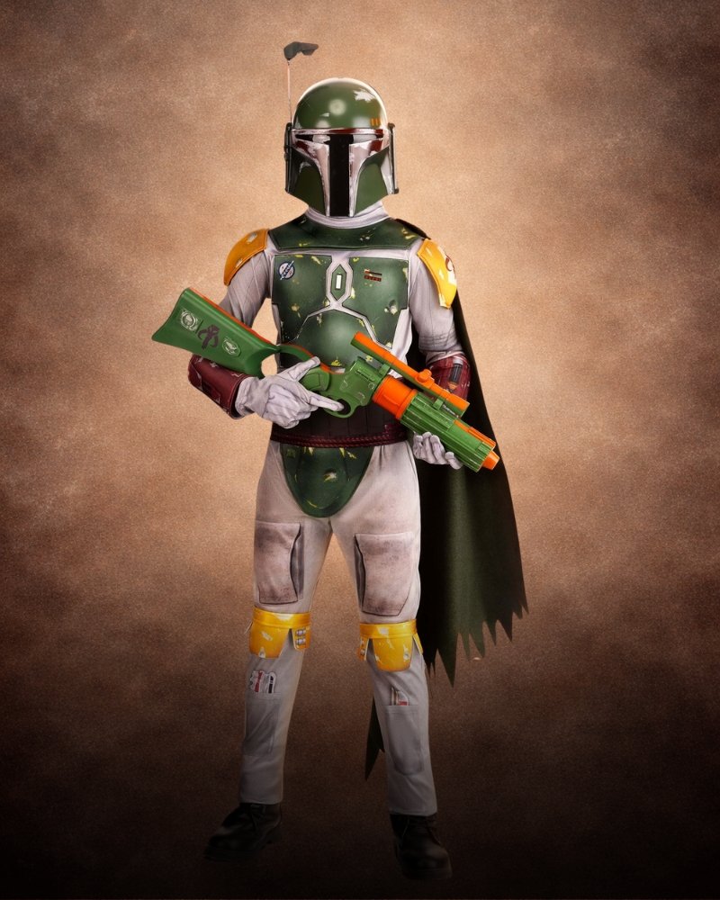 Deluxe Star Wars Boba Fett Costume with battle-worn green armor, gray jumpsuit, Mandalorian helmet, utility belt, and green cape.